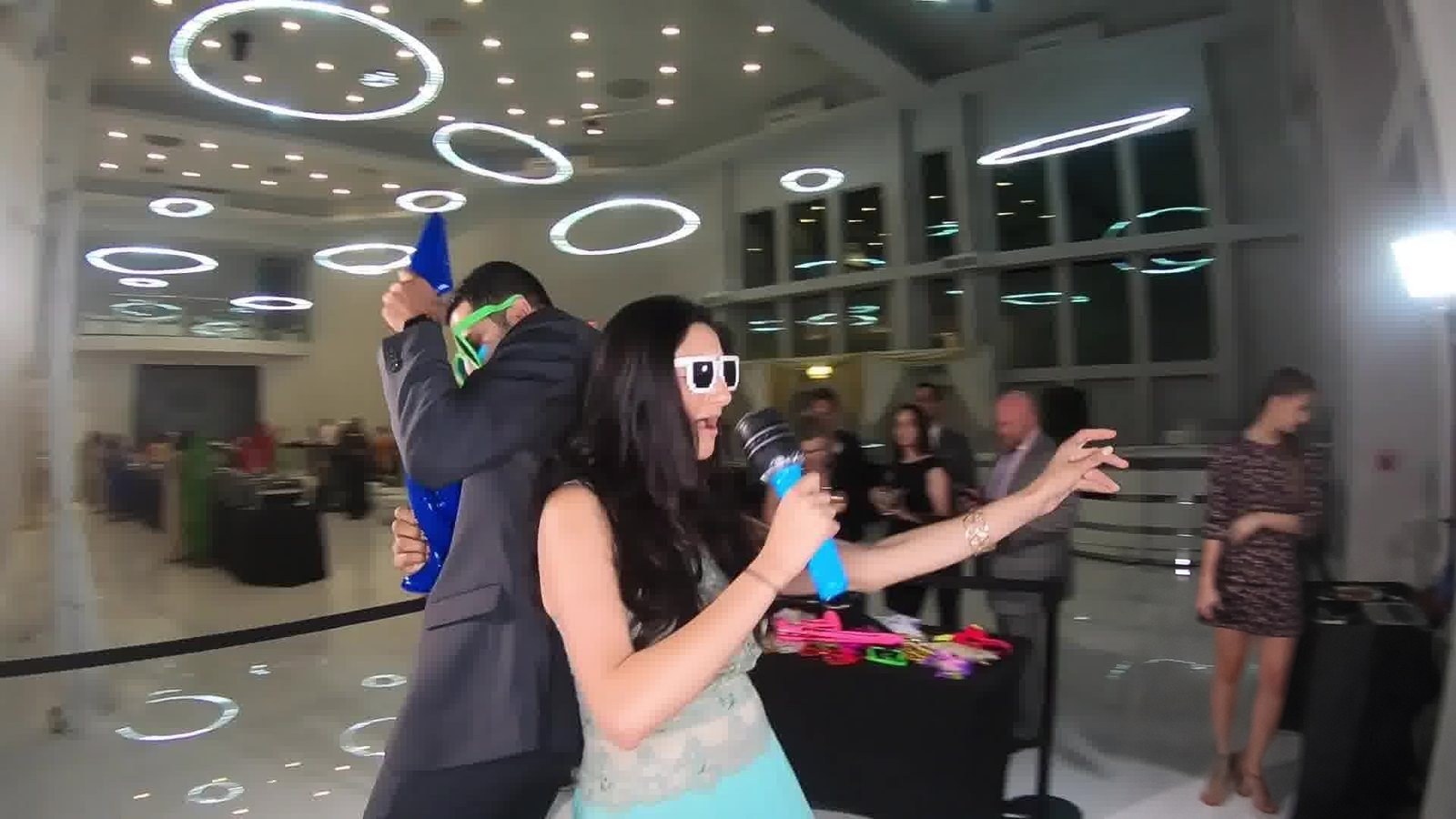 Guests in oversized glasses dancing on the 360 booth platform
