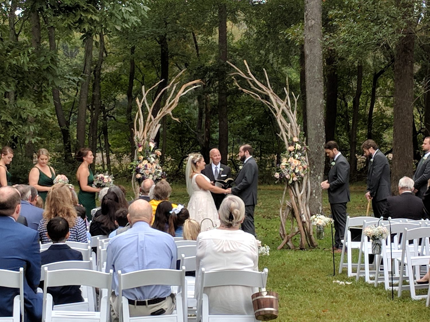 Ceremony arch framed against trees