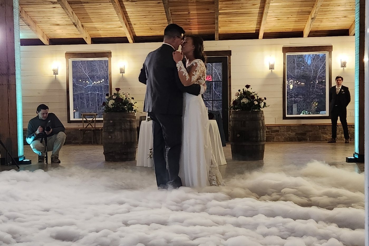 Couple sharing a first dance inside an ankle-deep dry-ice cloud