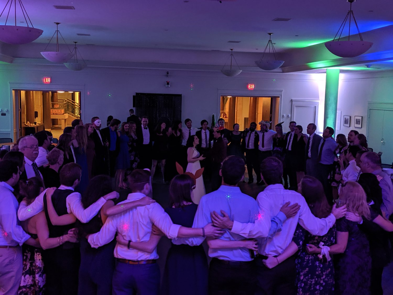 Packed dance floor under blue and gold lighting