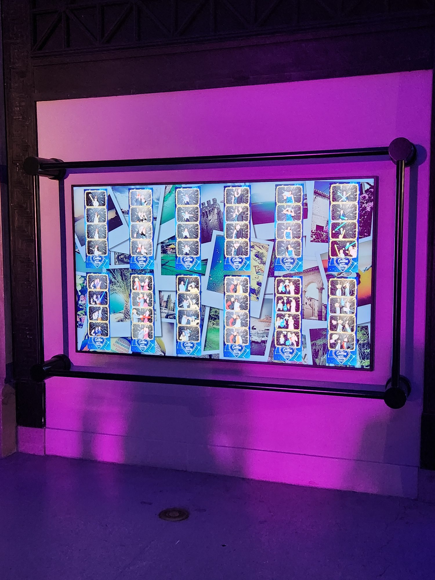 Guests laughing inside an open-air photo booth setup at a reception