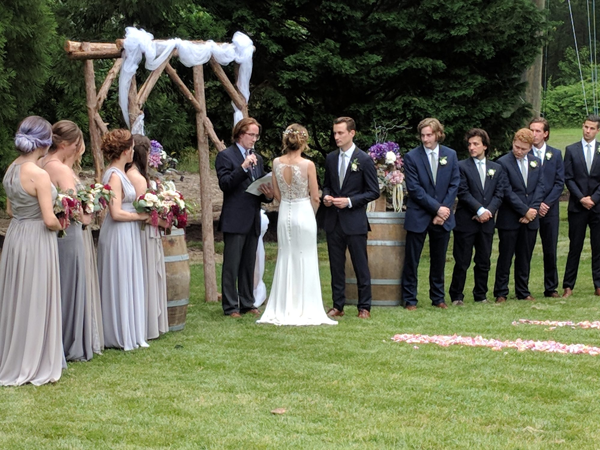 Elegant outdoor ceremony arch styled with white florals