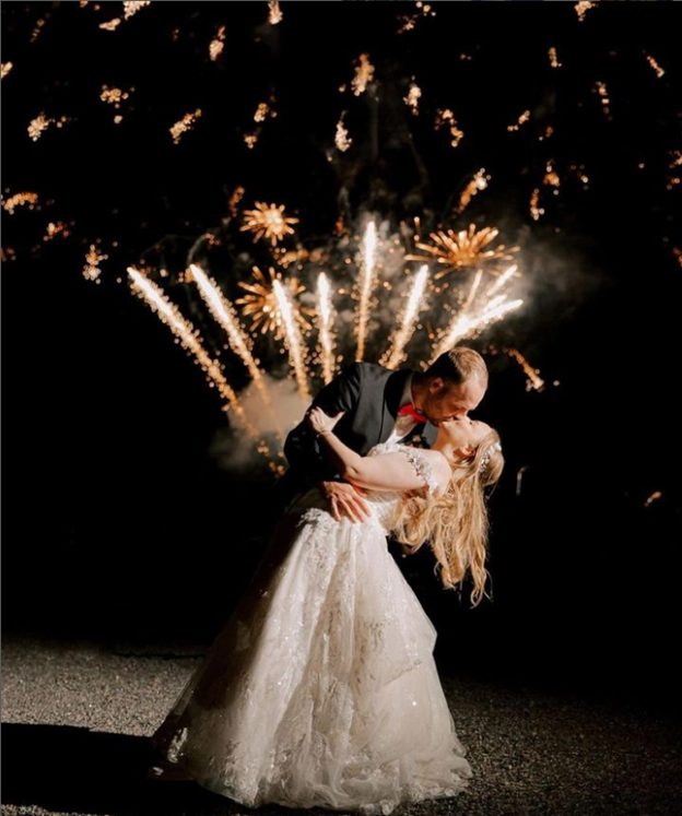 Newlyweds framed by a fireworks finale at an eastern Virginia wedding reception