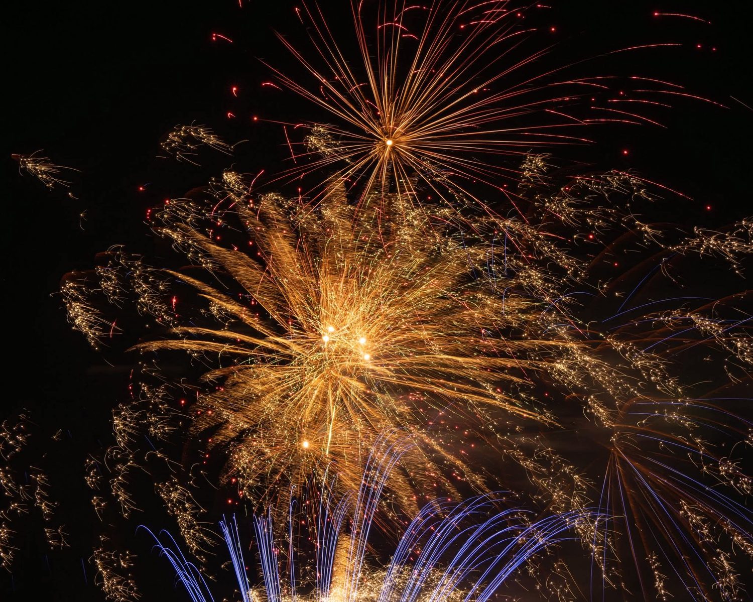 Aerial fireworks shell bursting in gold over a wedding venue